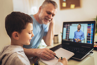 Schoolboy being educated online by home-educating father